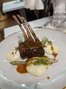 a plate of food with meat and vegetables on a table at Bes Hotel Terme a Palazzago in Palazzago +94 photos