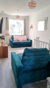 a living room with two blue couches and a couch at Self Catering Appartment 1 bedroom 2 double beds in East Cowes