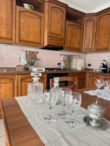 a kitchen with a table with wine glasses on it at A casa di Giulia in Ponte dellʼAgrato +19 photos