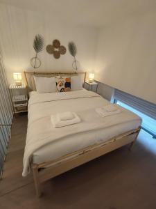 a bedroom with a large bed with two towels on it at Boutique Loft, Stylish, Cozy and Luxurious style apartment in wonderful building with 2 Pools & Gym in Dubai +55 photos