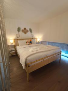 a bedroom with a large bed with two lamps at Boutique Loft, Stylish, Cozy and Luxurious style apartment in wonderful building with 2 Pools & Gym in Dubai