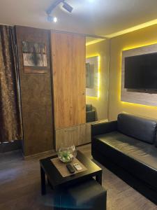 a living room with a couch and a table at Skopje Apartment in Skopje +17 photos