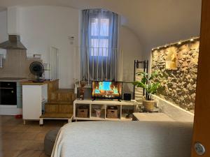 a bedroom with a bed and a tv in a room at Calonge Ca la Noni in Calonge