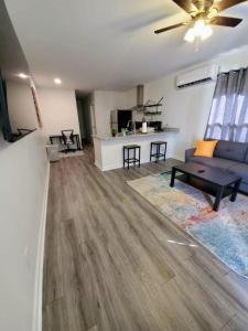 a living room with a blue couch and a table at Lakewoodlyon Park Renovated Cottage Near Duke 26a in Durham