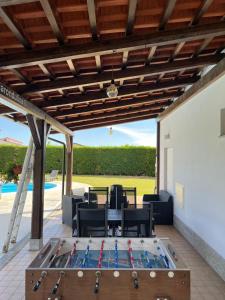 a pool table on the patio of a house at La RonduLina in Tigliole