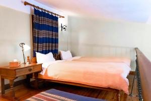 a bedroom with a bed and a desk and a bed at Dallia Loft Space in Goumenissa