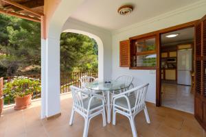 a patio with a glass table and chairs at Apartment Sol 2 in Port de Soller