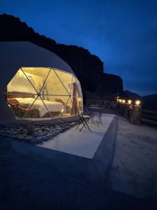 a tent is lit up at night at W6 View Dome - Jabal Shams in Sa‘ab Banī Khamīs +22 photos