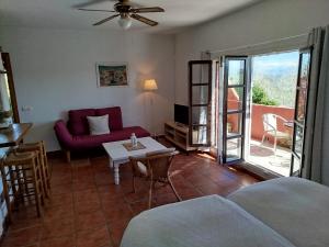 a living room with a couch and a table at Casa Montecote Eco Resort in Vejer de la Frontera