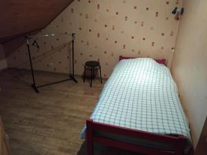 a small bedroom with a bed in a attic at Le Courcelot in Saint-Loup-sur-Aujon