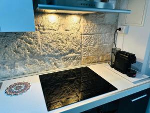 a kitchen with a counter top with a microwave at Nel cuore di Giovinazzo in Giovinazzo