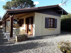 a small white house with a window and a porch at MF n 8 in Cazaubon