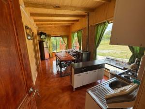 a kitchen and dining area of a caravan with a table at Casa de campo in Lago Ranco