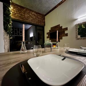a table with wine glasses and candles on it at Appart Massage Relax - Studio in Morbier +6 photos