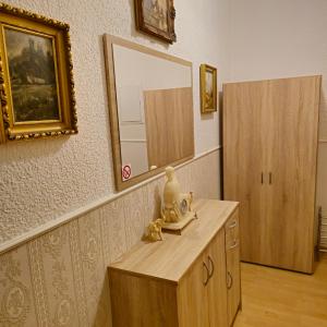 a room with a dresser and a mirror on a wall at Apartment 5 in Gera