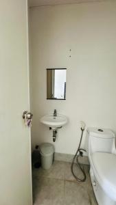 a bathroom with a white toilet and a sink at Condo unit in Novaliches Quezon City near Caloocan City in Manila +7 photos