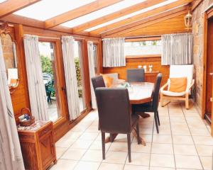 a dining room with a table and chairs at Holliday Home La Douane in Gedinne +41 photos