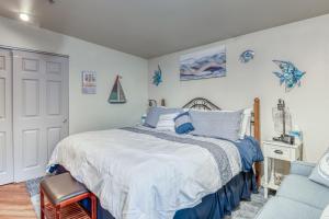 a bedroom with a bed and a blue chair at Luxury Oceanview Escape in Depoe Bay Book Your Stay at Tranquility Cove in Depoe Bay