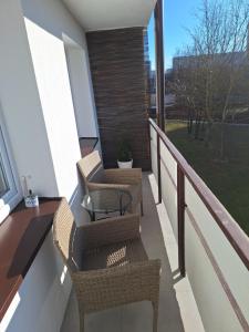 a balcony with two chairs and a table at Apartament 26 in Toruń