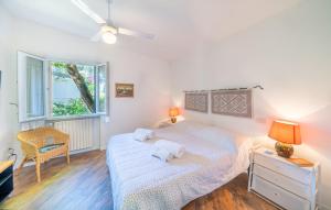 a bedroom with a bed and a chair and a window at Casa Ileana in Gargnano +34 photos