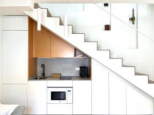 a kitchen with white cabinets and a staircase at Casa Torre Hacho in Antequera +145 photos