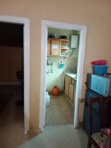 a kitchen with a door open to a kitchen with a sink at PINE Apartment bhurban Murre in Rāwāt