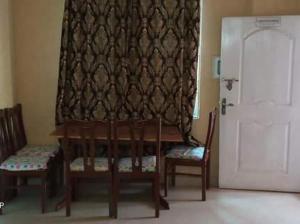 a room with two chairs and a table with a curtain at PINE Apartment bhurban Murre in Rāwāt