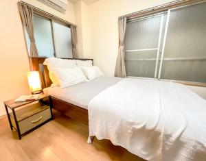 Postel nebo postele na pokoji v ubytování Asakusa HK Apt-1