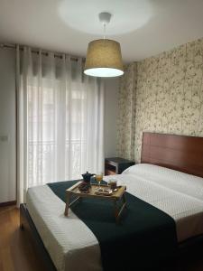 a bedroom with two beds and a table with a coffee table at PISO Bueu Playa in Bueu