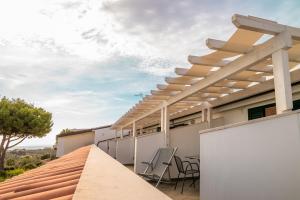 a patio with a table and chairs on a roof at Residence Chiesiola in Vieste