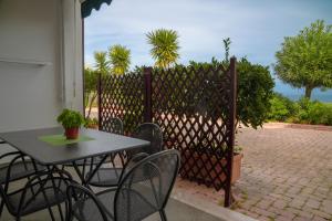 a patio with a table and chairs and a fence at Residence Chiesiola in Vieste
