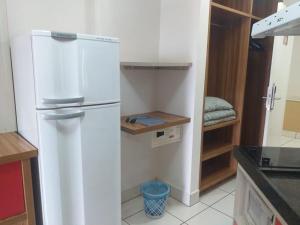 a kitchen with a white refrigerator in a room at residencial diroma exclusive in Caldas Novas