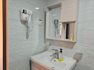 a bathroom with a sink and a phone on the wall at Wadi Rum Luxury Hamad & Jeep Tours in Wadi Rum +93 photos