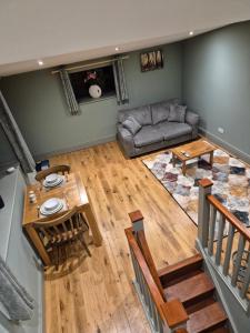 an overhead view of a living room with a couch and a table at Charming 1 bed Peak District Barn Conversion in Foolow