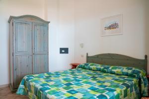 a bedroom with a bed and a cabinet at Residence Chiesiola in Vieste