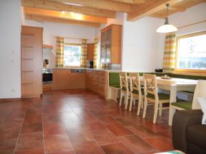a large kitchen with a table and chairs at Ferienhaus Longa in Weisspriach