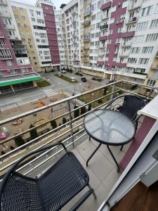 a balcony with a table and chairs and buildings at Brown Aparts in Chişinău