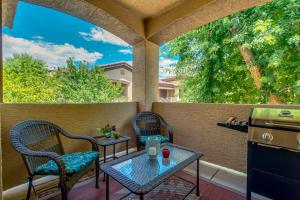 a patio with two chairs and a table and a stove at Southern #2055 Mesa in Mesa
