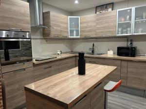 a kitchen with wooden cabinets and a counter top at Maison avec piscine in Gaillac