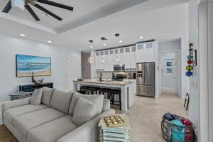 Una sala de estar con un sofá y una cocina. en Sunrise Island Retreat, en Fort Pierce