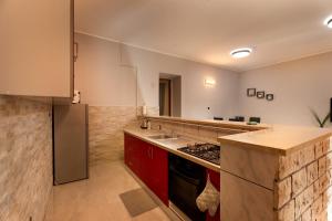 a kitchen with a sink and a stove top oven at Casa Del Mar Apartments in Pula
