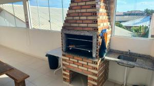 a brick oven sitting next to a window at Casa Brisa Nordeste in Palhoça