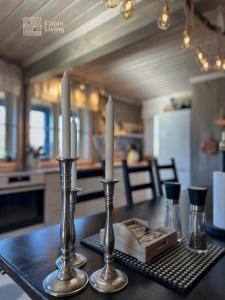 two candles on a table in a kitchen at Cozy mountain cabin with sauna, fireplace & bbq in Flå