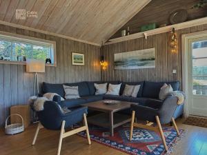 a living room with a blue couch and a table at Cozy mountain cabin with sauna, fireplace & bbq in Flå