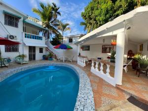 a villa with a swimming pool in front of a house at Villa Antonia 16 in Sosúa