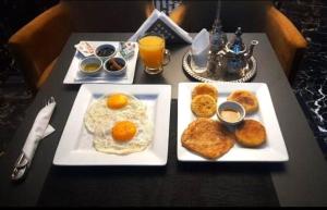 a table with two plates of breakfast food on it at The Hotel Syracuse in Casablanca