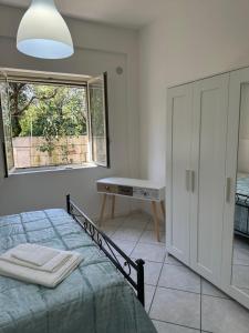 a bedroom with a bed and a window at In famiglia rooms for Pompei, Amalfi, Sorrento, Napoli e Salerno in Sant'Egidio del Monte Albino