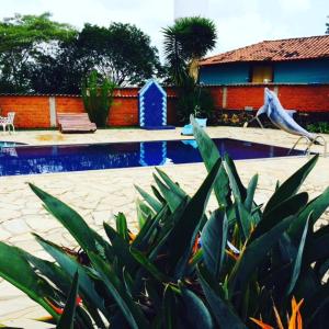a swimming pool in front of a house at Pousada Recanto Das Pedras in Tiradentes