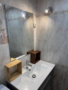 a bathroom with a white sink and a mirror at Piso Sofia in Empuriabrava +18 photos