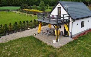 an overhead view of a small house with a deck at Mazurkowo domek Gaj-Grzmięca in Zbiczno